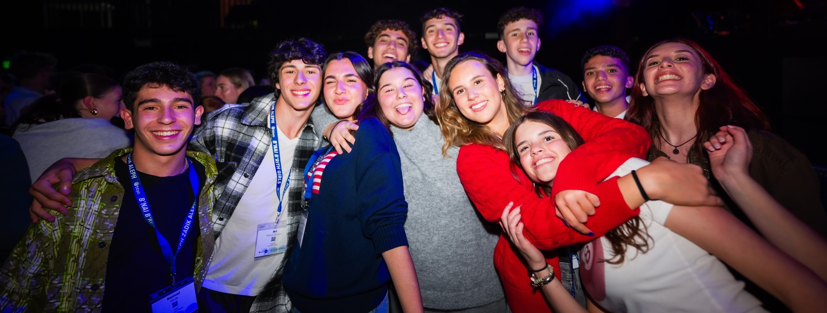 Un groupe de jeunes de tous horizons souriant lors d'un événement communautaire